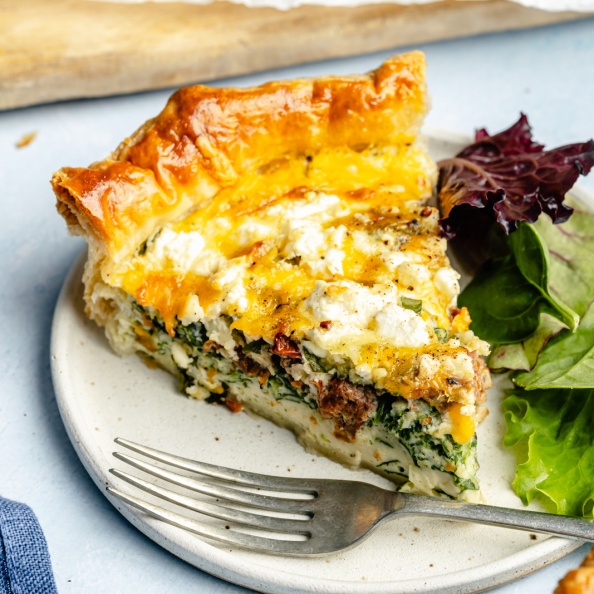 slice of spinach puff pastry quiche on a plate