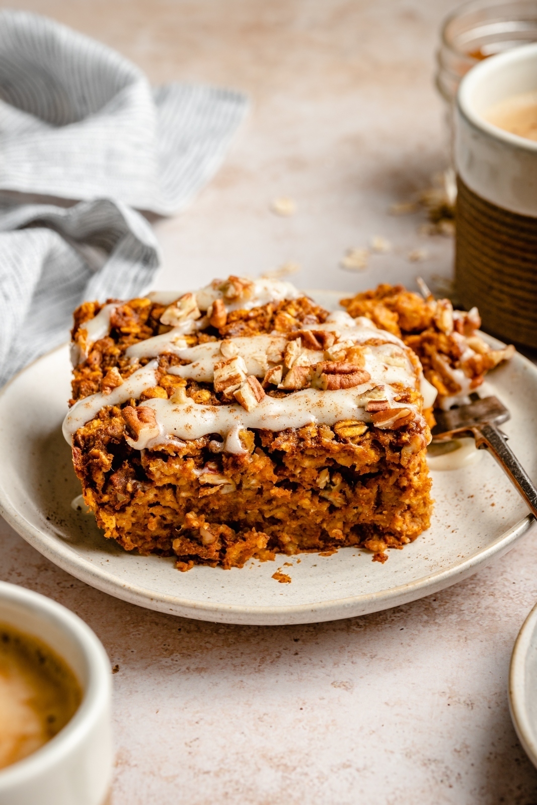 slice of pumpkin baked oatmeal with glaze on a plate