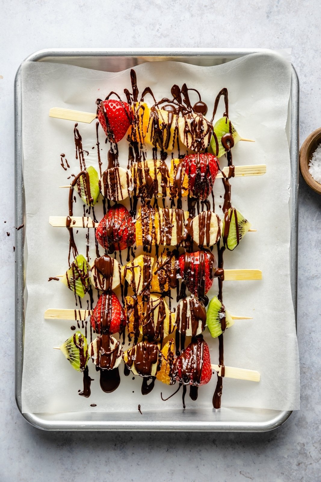 healthy fruit skewers drizzled with chocolate