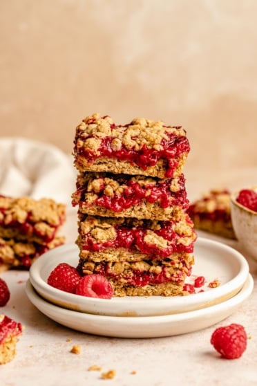 healthy raspberry bars in a stack on a plate