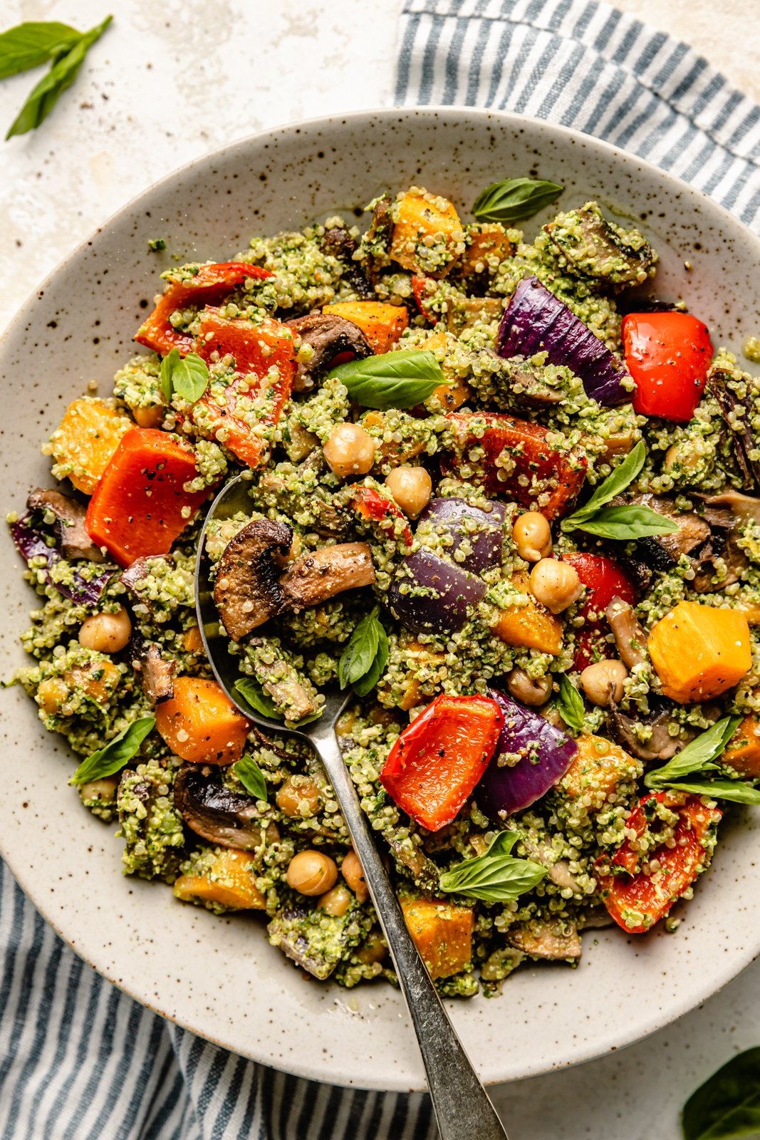 pesto quinoa salad with vegetables in a bowl