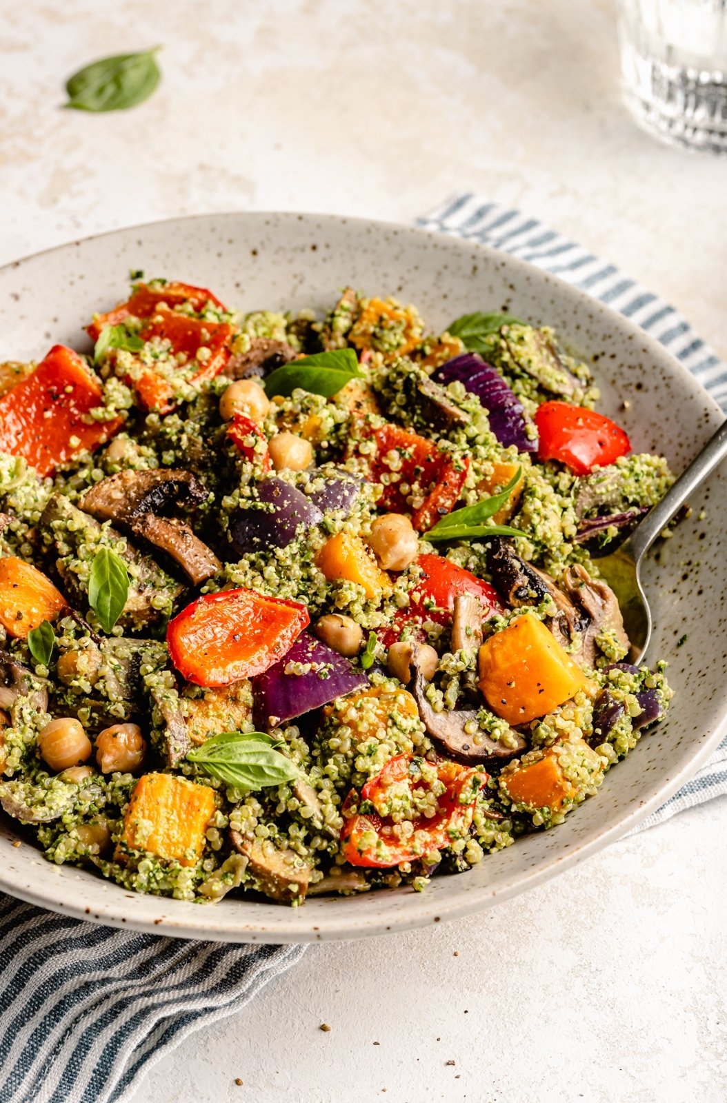 pesto quinoa salad with roasted vegetables in a bowl