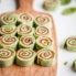 smoked salmon pinwheels on a wooden board