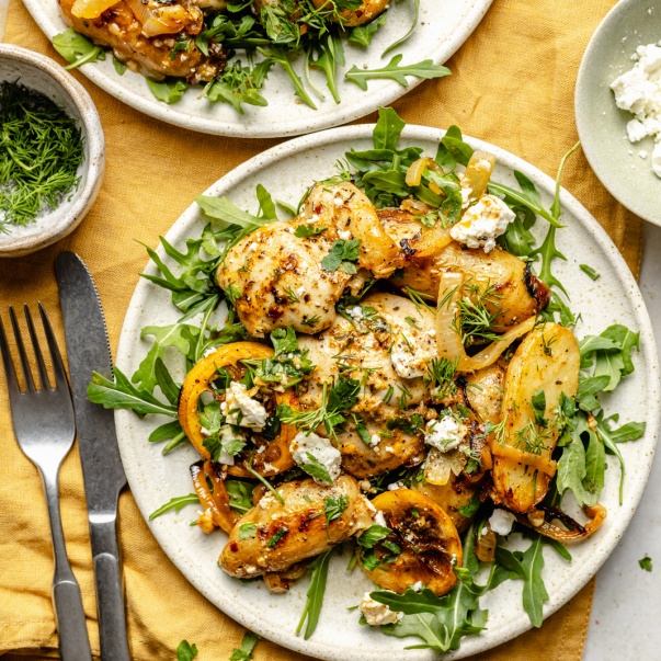 lemon chicken and potatoes on a plate with arugula