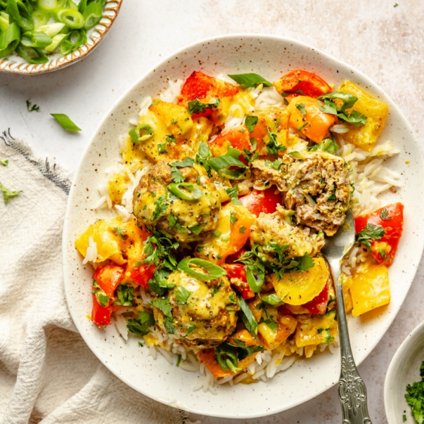 zucchini chicken meatballs in a bowl with rice and vegetables