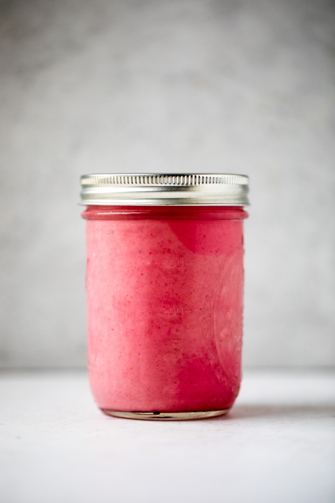 pink smoothie in a mason jar