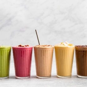 different colored smoothies all lined up