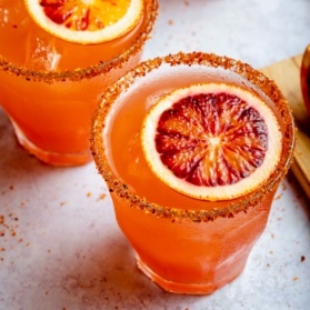 two blood orange margaritas in glasses