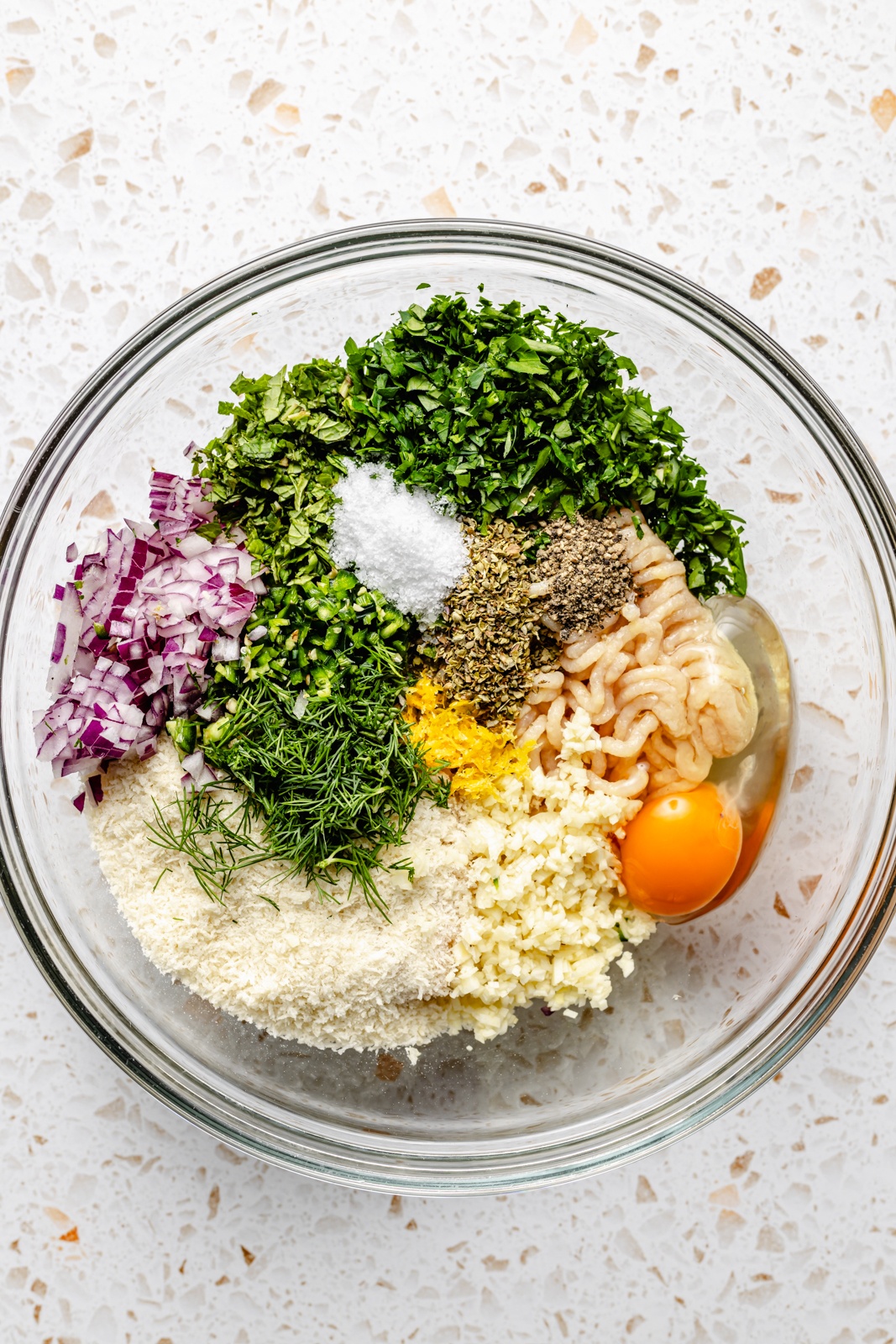 ingredients for herby chicken meatballs in a bowl