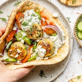 folding up an herby chicken meatball pita