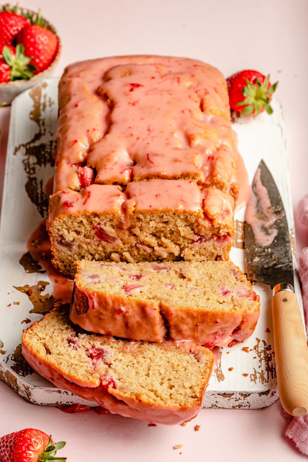 healthy strawberry bread sliced on a cutting board