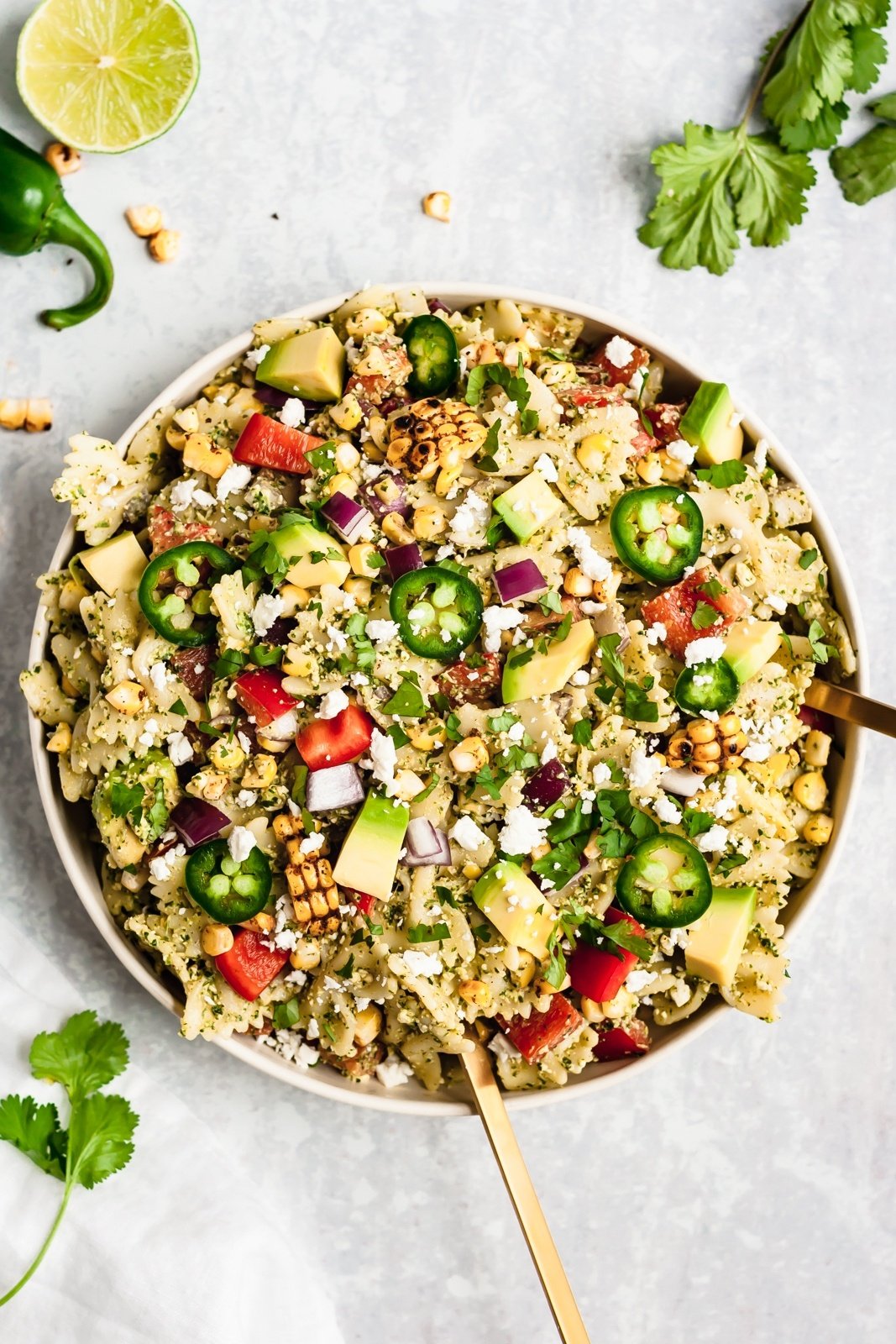 street corn pasta salad in a bowl with serving utensils