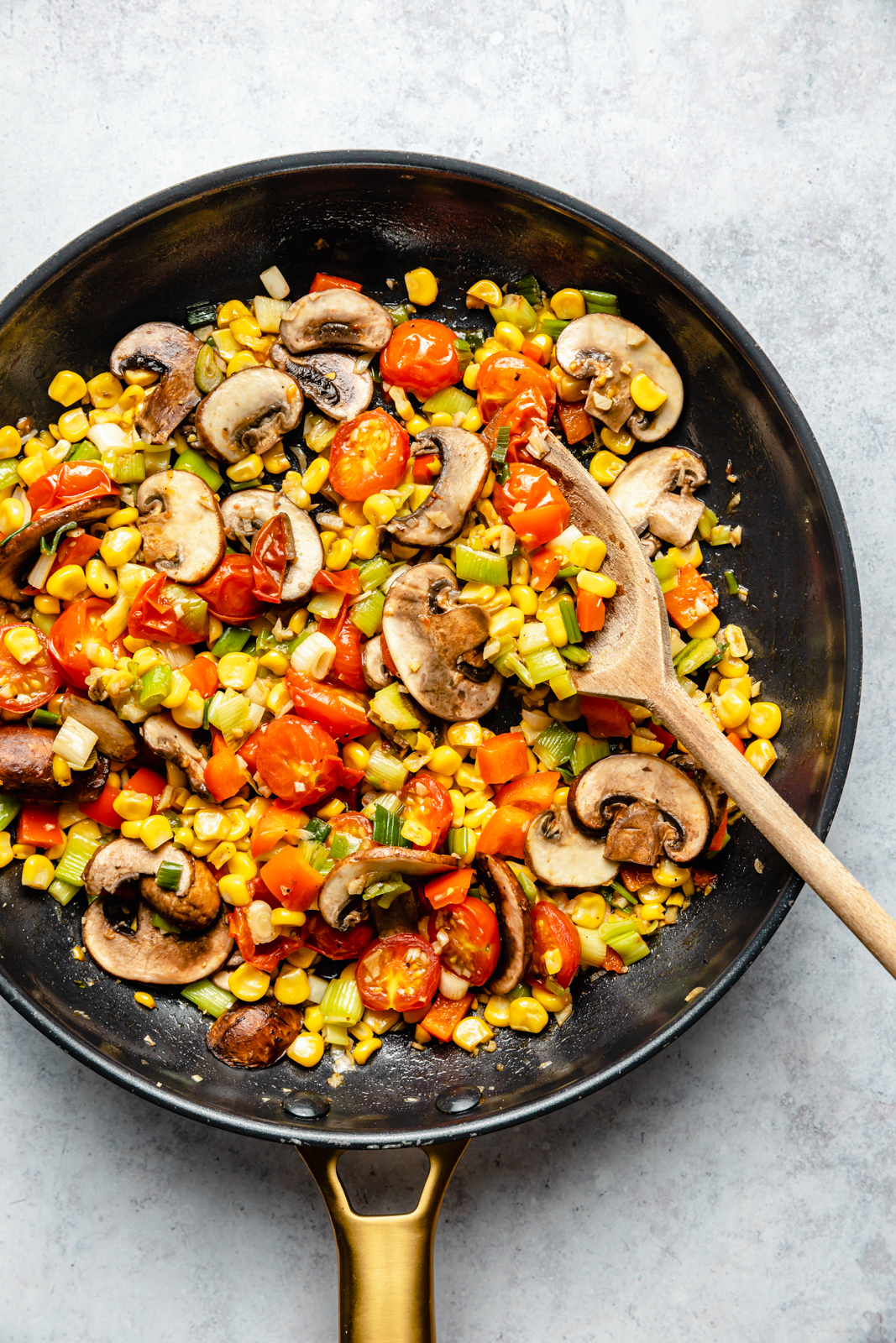 cooking vegetables in a skillet for a zucchini pie