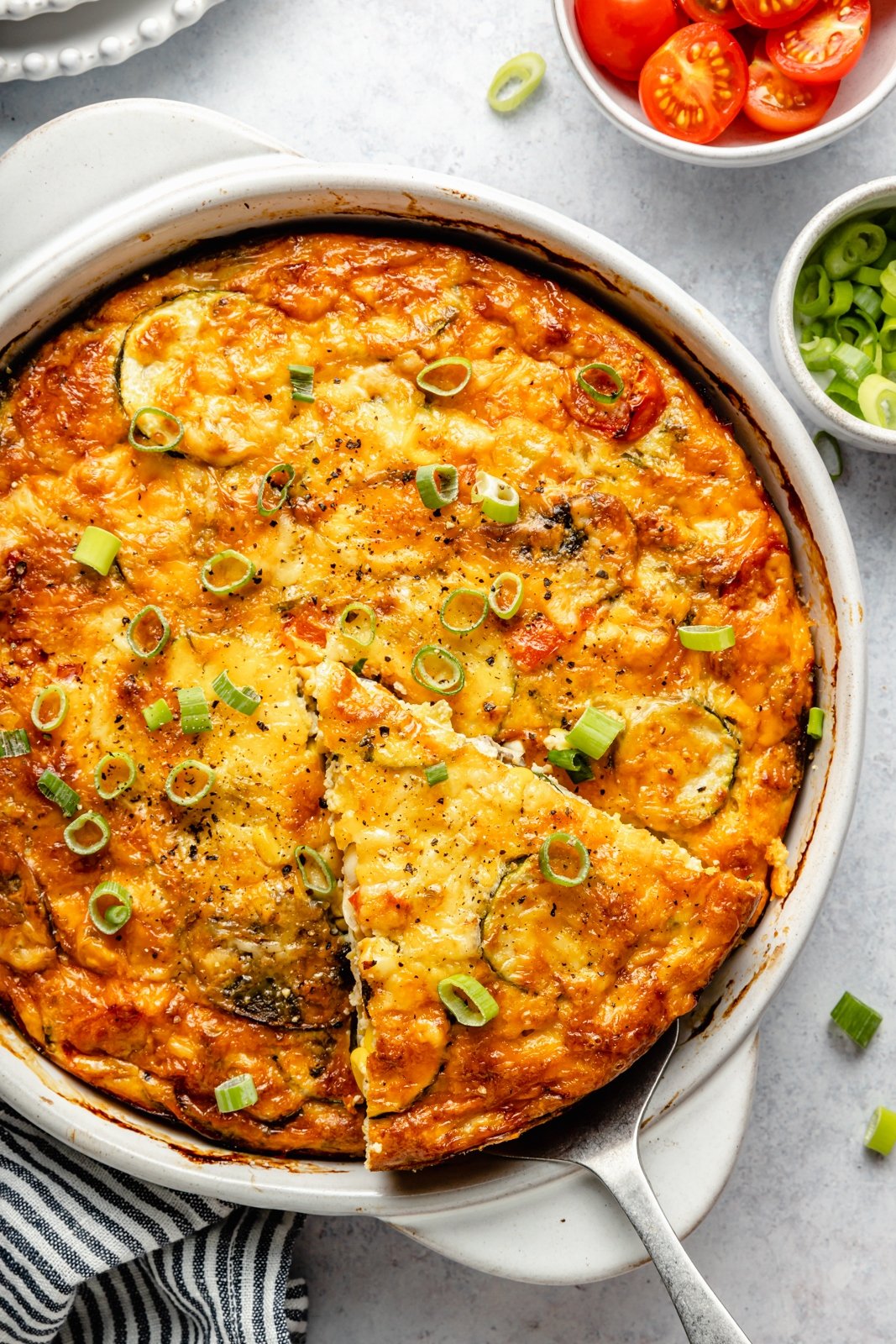 zucchini pie with fresh tomatoes in a baking dish