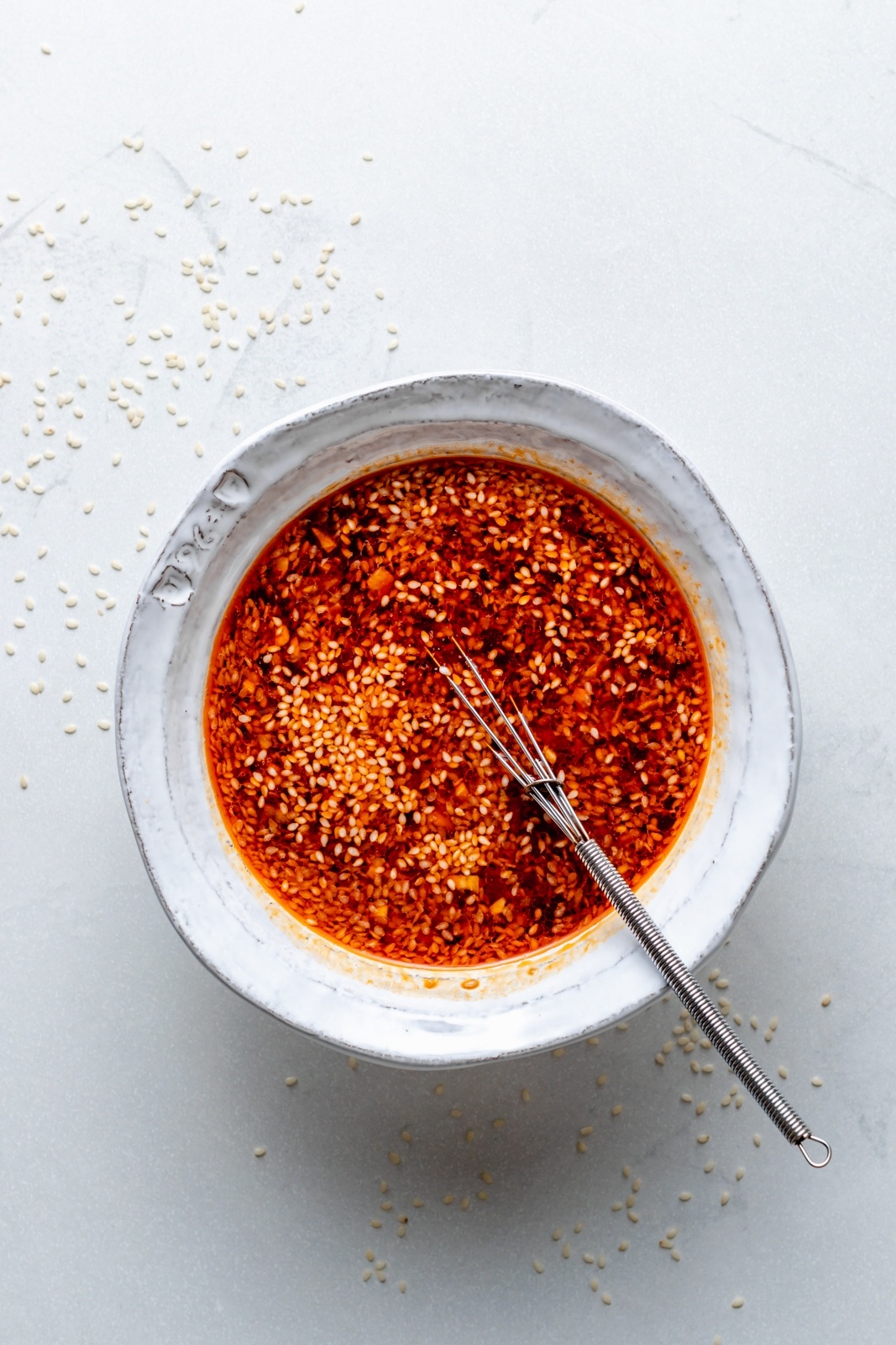 mixing sauce for sesame chicken meatball bowls