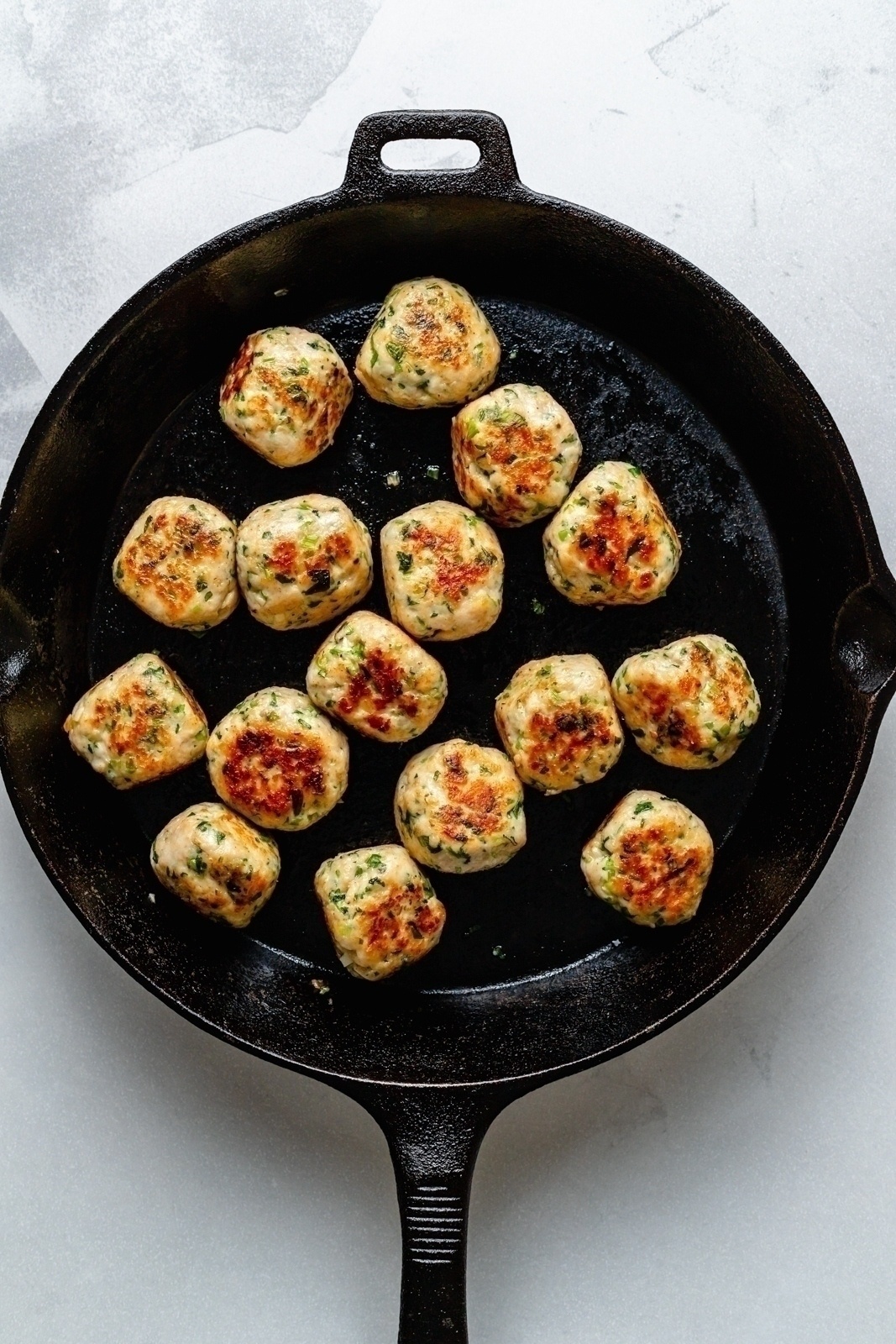 healthy sesame chicken meatballs in a skillet