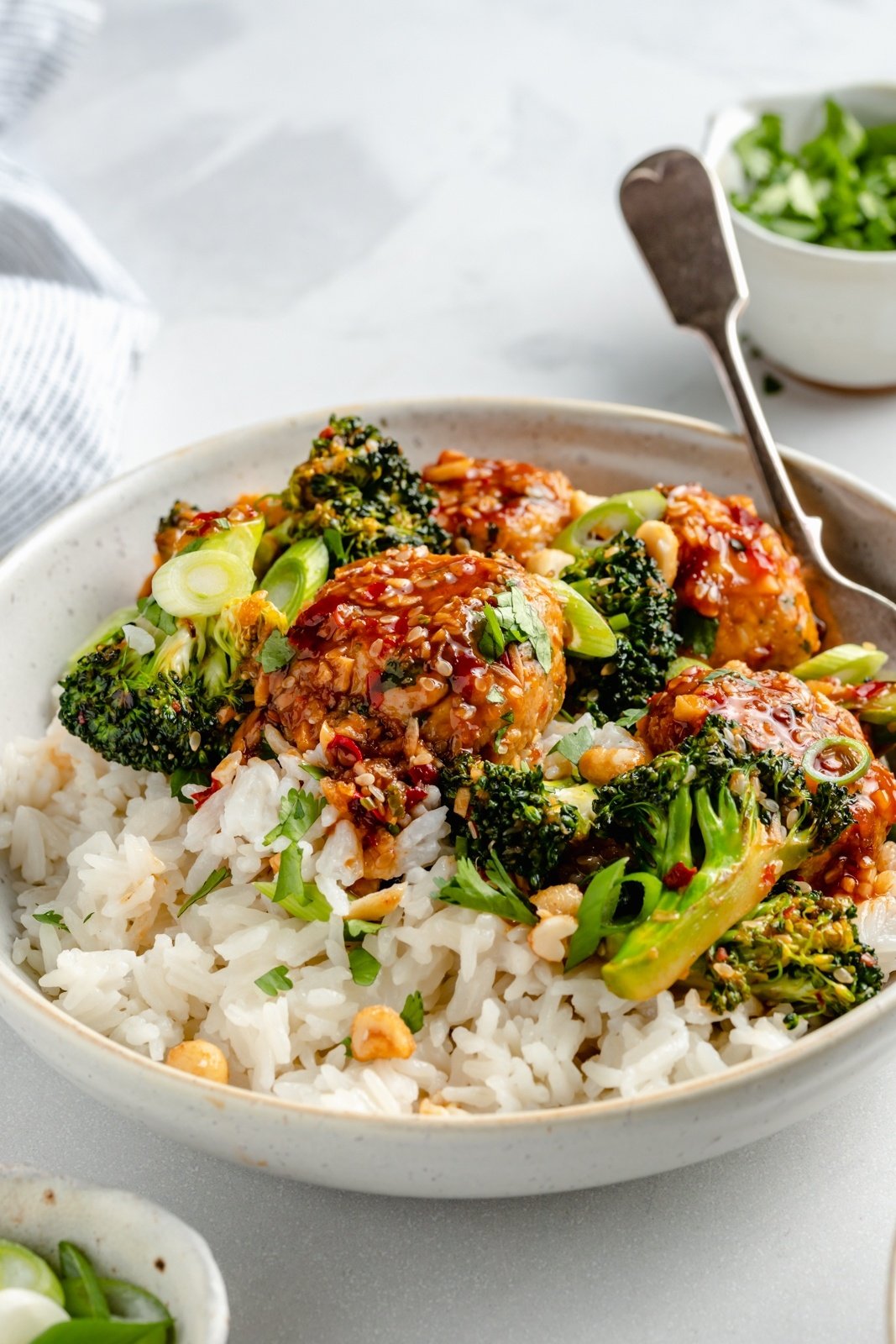 one pan sesame chicken meatballs with broccoli in a bowl with rice