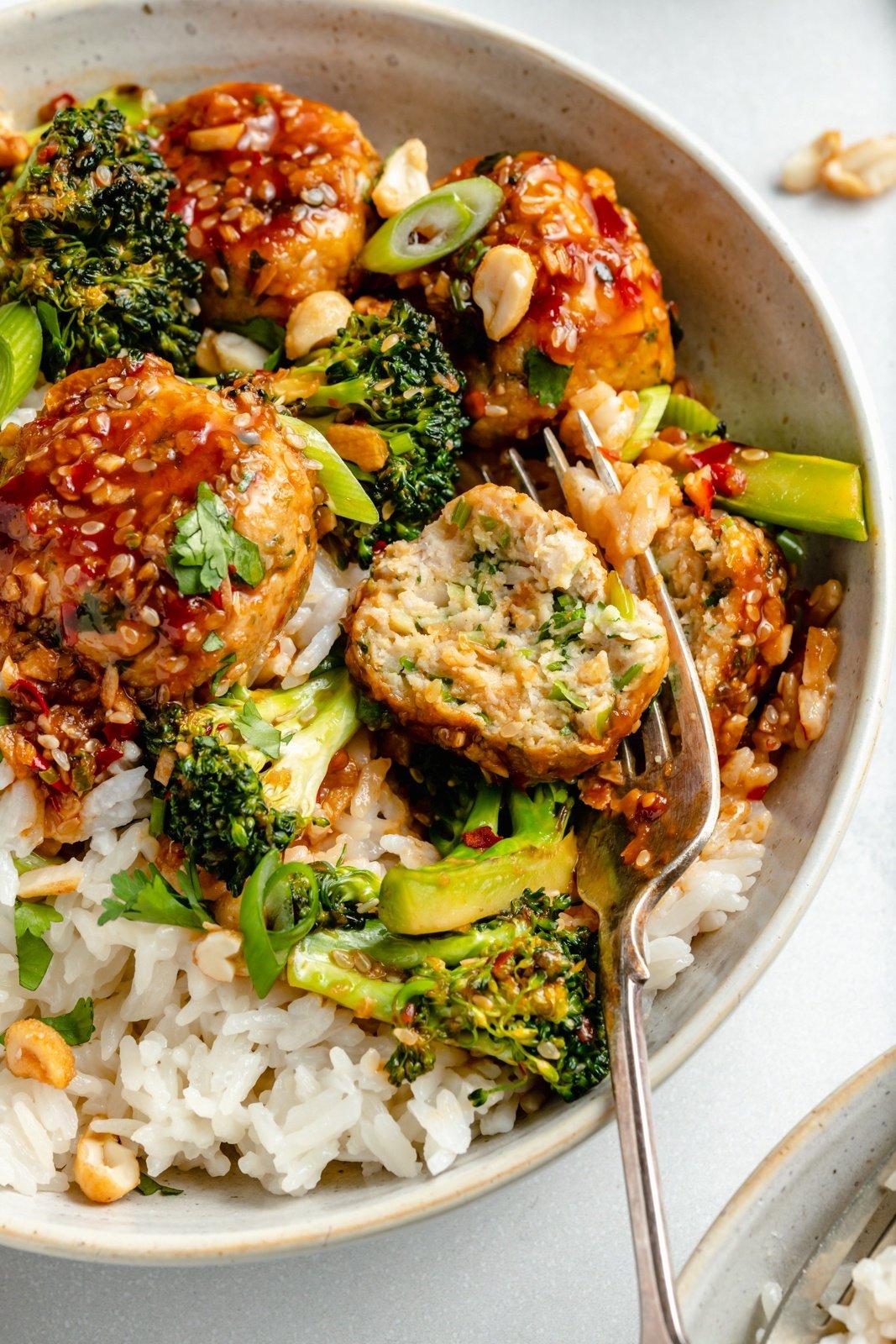 up-close view of healthy sesame chicken meatballs bowls with rice and broccoli