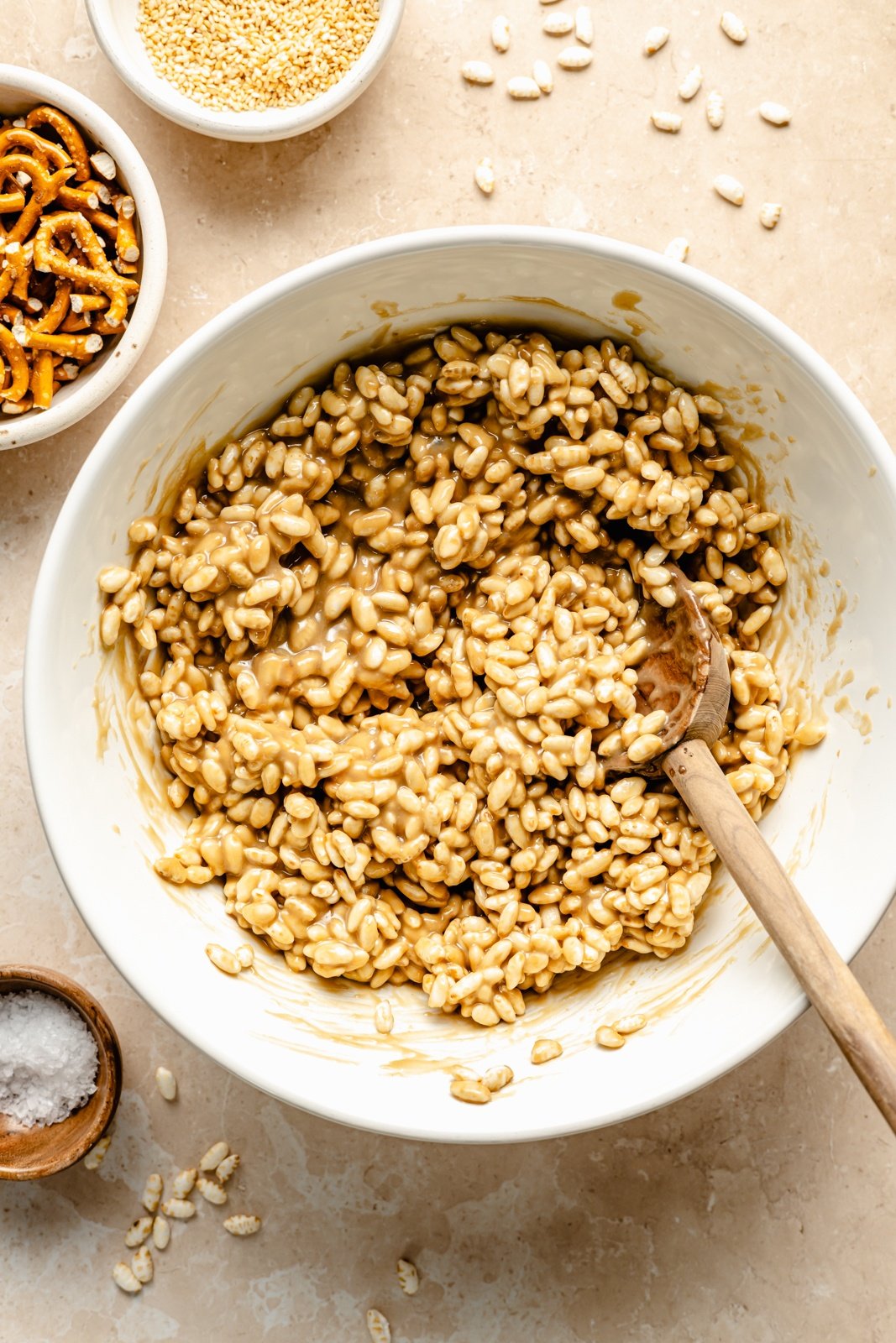 mixing ingredients for chocolate tahini rice krispie treats in a bowl