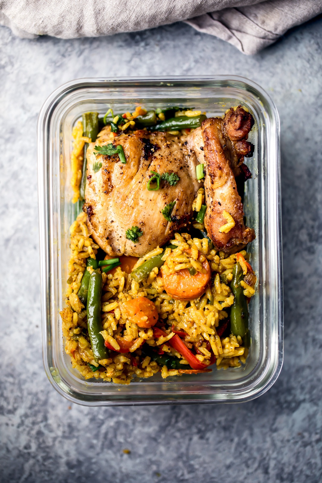 one pan yellow curry chicken and rice in a glass meal prep container