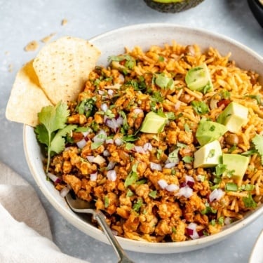 turkey picadillo in a bowl with tortilla chips