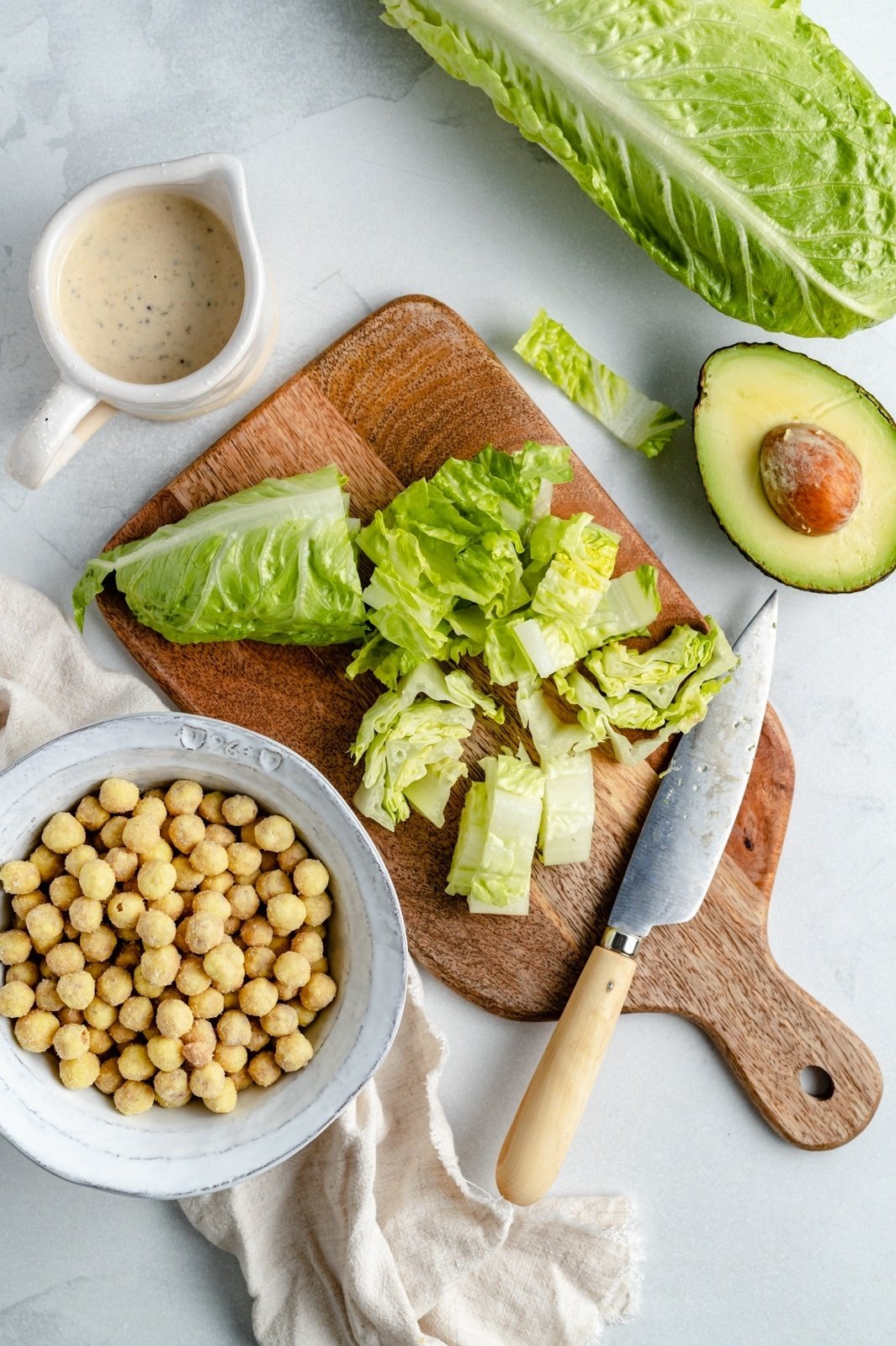 ingredients for vegan caesar salad recipe on a board