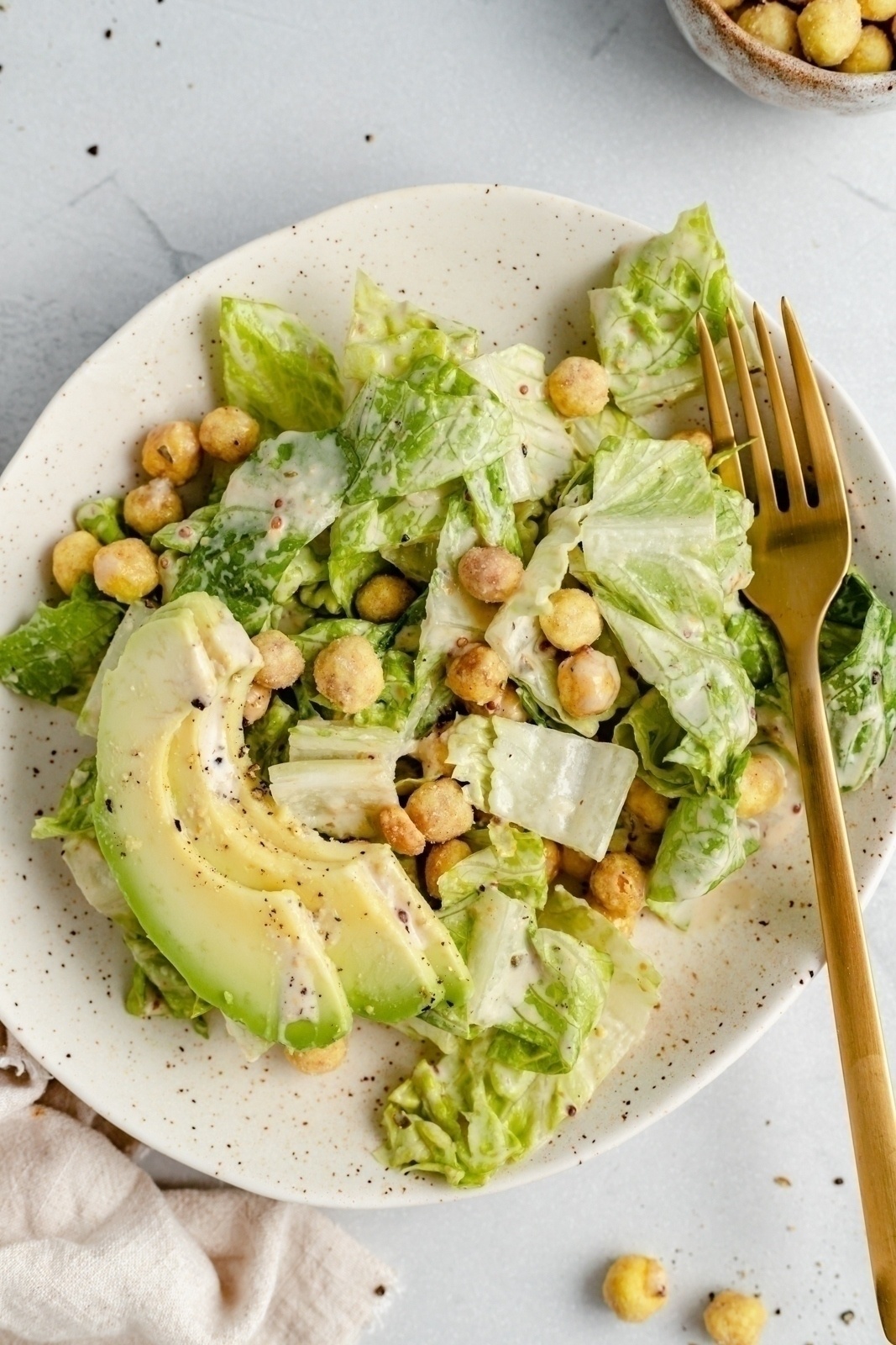 the best vegan caesar salad on a plate with a fork