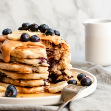 fluffy vegan pancakes in a stack on a plate