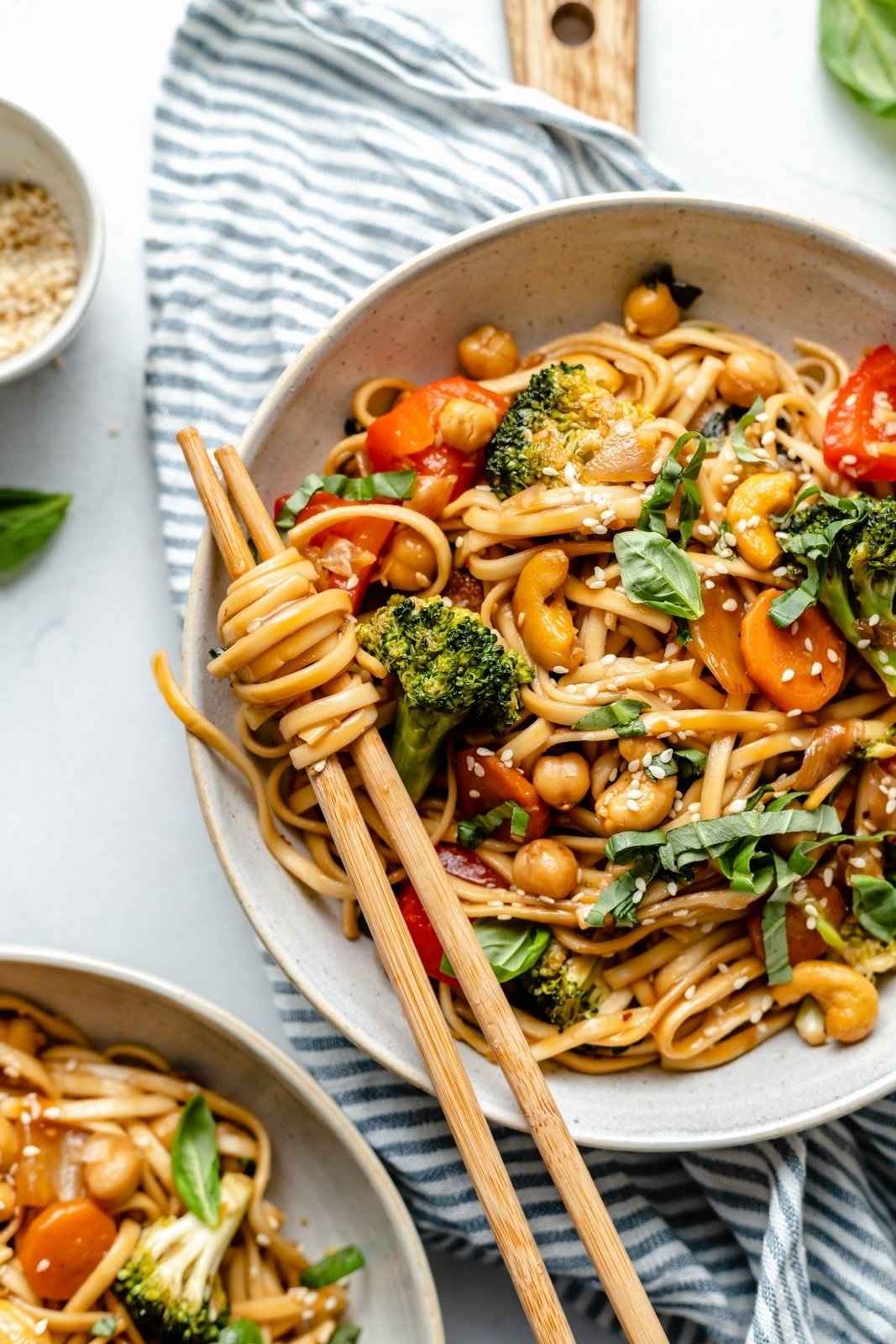 stir fry noodles in a bowl with vegetables and chopsticks