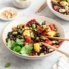 bowl of vegetarian fried rice with pineapple, red bell pepper, and chopsticks