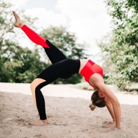 monique doing yoga in the sand