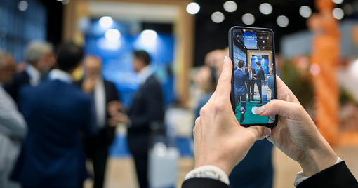 An attendee taking a picture with a mobile phone