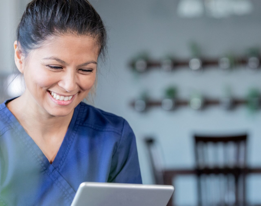 Healthcare professional using a tablet to communicate with a patient