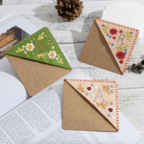 three embroidered bookmarks