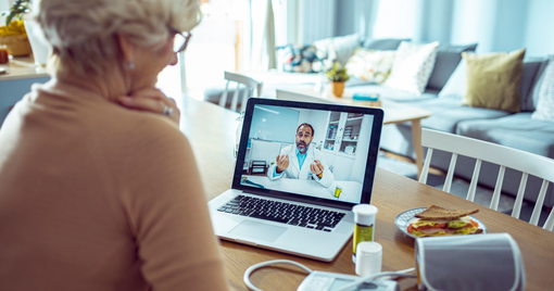 Close up of a senior woman consulting with her doctor online on her laptop